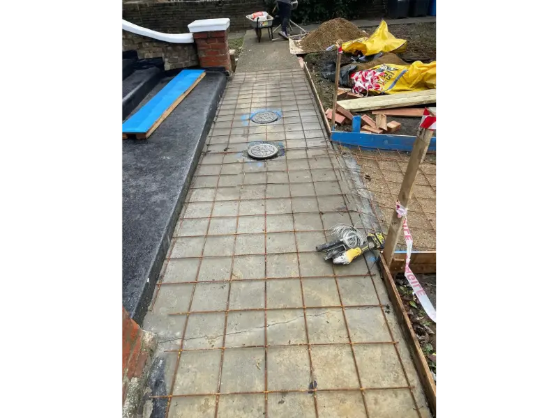 Steel reinforcement mesh installed for new concrete pathway at front driveway landscaping project in Berkshire
