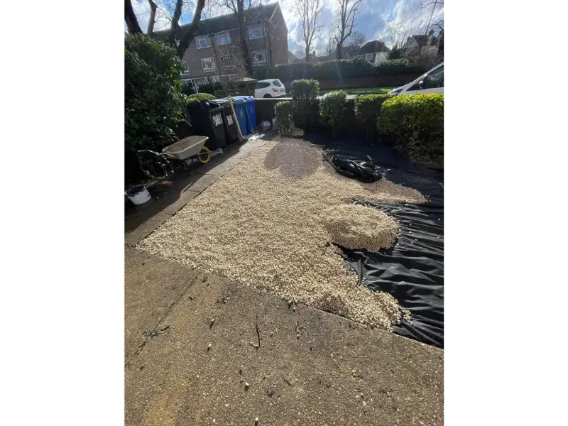 Ground preparation with membrane sheet for gravel landscaping in front garden Berkshire