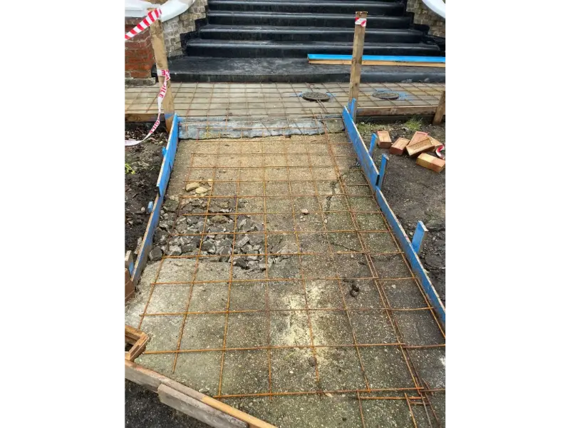 Front garden boundary wall and driveway edge preparation during landscaping project in Berkshire